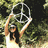 Pixelated image of a person with raised arms holding a circular object against a blurred green and black background.