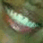 A close-up of a smiling mouth with visible teeth and lips, displayed in a of four with slight variations in lighting and color tone