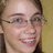 A pixelated image shows a person with light skin and glasses on the left, next to green text reading "IT'S KATE" on a black background.