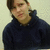 A person in a dark blue hoodie against a light background, shown across three views with subtle pose changes.