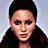 Pixelated image of a woman in a brown bra and green shorts, showing multiple views of her upper body and torso.