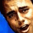 Pixelated close-up of a person's face with blue background, static single-frame image.