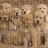 Pixelated image of multiple light brown dogs on a textured background with blue text labels on a yellow field.
