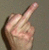 Static pixelated image of a hand making an offensive gesture against a gray background.