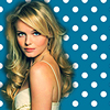 A woman with long wavy blonde hair and blue eyes wears a white sleeveless dress against a blue background with white polka dots.