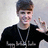 A person in a black shirt with white text and a silver chain makes a peace sign with their right hand against a light gray background.