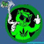 Green cartoon character with large black eyes and a wide grin, holding white objects resembling bones or sticks in both hands against a blue background.