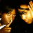 Two golden, pixelated hands face each other against a black background with faint green and brown speckles.