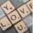 A static pixelated icon shows four cartoonish faces arranged in a diamond pattern around a central spiral, with muted beige and brown tones on a gray background.