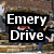 Animated sequence showing a group of people in front of a stone archway with text overlays changing between 'Emery Drive' and 'Vote!' while URLs remain constant.