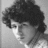 Black-and-white pixelated image of a person with curly hair, featuring pink text reading 'dude!uh...sir' in the top-right corner.
