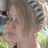 Pixelated image of a person with light brown hair and a green garment on a solid blue background with pink text reading "Hola" and "I'm Jeanmarie !"