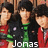 A pixelated image of multiple young men in red and green jackets with black hair, overlaid with text reading "Jonas brothers" and "my LIFE".