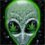 Green pixelated alien head with large black eyes and purple highlights, set against a dark background with scattered light specks.
