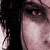 A pixelated image of a person with dark hair and light skin, showing multiple overlapping facial views in shades of pink and black.