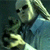 A pixelated figure with long hair holds a dark object, with a bright yellow glow appearing in the lower right quadrant