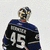 Pixelated image of a person wearing dark blue and black sports jersey with number 45, standing against light gray background.