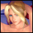 Pixelated image of a blonde woman with blue eyes resting on a purple surface, next to text reading 'Anime IM' and 'com'.
