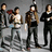 Pixelated image of four people standing together with blue text on a dark background describing each person's traits.
