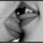 Pixelated grayscale image of a cartoon character with large eyes, dark hair, and an open mouth in profile view against light background.
