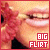 repeated close-up images showing a person's mouth with red lips and teeth, overlaid with 'BIG FLIRT' text in pink and white