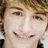 A pixelated close-up of a person's face with light brown hair, showing two slightly different expressions side-by-side.