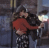 A pixelated animated icon shows two people embracing in a red and black outfit against an urban background, with changing text overlays.