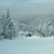 Pixelated image divided into four quadrants showing a snowy landscape, green text on blue background, red text on blue background, and solid gray area.
