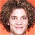 A 50x50 pixel buddy icon split into two sections: a person with curly brown hair on an orange background and green text reading "Original Icons .com" on a dark green background.