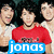 Three people pose together with a blue banner displaying 'jons' in white text at the bottom.