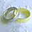 Animated sequence of two interlocking rings in yellow and silver tones against a light background, showing subtle rotation.