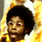 Pixelated static image of a character with dark curly hair and light skin against a bright yellow background, likely from an Austin Powers movie reference.
