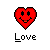 Red pixelated heart with black outline, smiling face featuring two circular eyes and a mouth with orange tongue detail, positioned above the word 'Love' in blocky font on gray background.