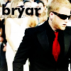 A pixelated image shows a person in a black suit with a red tie, wearing sunglasses, standing in front of a blurred background with the word 'bryar' in large black letters.