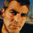 Pixelated close-up of a person's face with warm skin tones and dark hair against a blurred background, rendered in low-resolution 48x48 pixels.