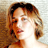 Static 48x48 pixel icon showing a close-up of a woman's face with brown hair and light skin, rendered in low-resolution pixel art style against a neutral background.