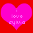 Two identical pink hearts on red background with white text reading 'i love sylvia' inside each heart.