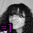 Pixelated grayscale image of a person with long dark hair and bangs, featuring a purple '=]' symbol in the lower-left corner.