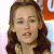 A pixelated close-up of a person with long brown hair, light skin, and a neutral expression, set against a blurred background with pink, blue, and orange tones.