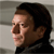 Pixelated side-profile image of a person with dark hair, light skin, and a neutral expression against a gray background.