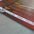 A pixelated image with a diagonal white streak across a blurred background of brown, red, and gray tones.