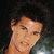 five distinct images featuring a young man with dark curly hair, including close-ups and full-body shots against various backgrounds