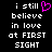 Black background with white pixelated text reading 'i still believe in love at FIRST SIGHT' and a pink pixelated heart symbol replacing the 'o' in 'still'.