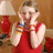 A pixelated image of a person in red clothing holding a colorful object near their face, next to text reading "little miss sunshine :)" on a solid red background.