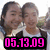 Two identical figures with dark hair and white shirts stand side-by-side, each wearing a black jacket over the shirt. The left figure has pink text reading "05.13.09" below them; the right figure has orange text reading "ily <3".