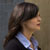 Pixelated profile view of a person with dark hair wearing a light-colored top against a gradient background.