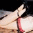 A woman in a red dress with white trim appears in two sequential poses: first lying down with one arm raised, then sitting up with hands near her face.