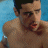 A pixelated image of a shirtless person with short dark hair against a blue background, next to green text reading 'Original Icons .com' on a dark green backdrop.