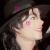 Pixelated close-up of a person with dark hair and light skin, showing a side profile with closed eyes and a neutral expression.