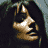 A 2x2 contact sheet of four pixelated frames showing a woman with long dark hair in various poses, including one frame with visible text "Coolbuddy.com" on a black background.